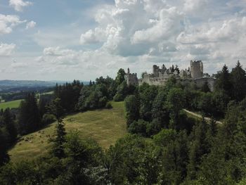 Panoramic view of trees and buildings against sky