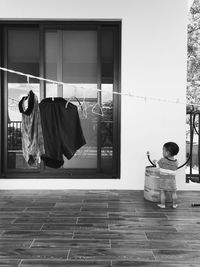 Full length of woman standing by railing
