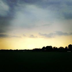 Scenic view of landscape against sky at sunset