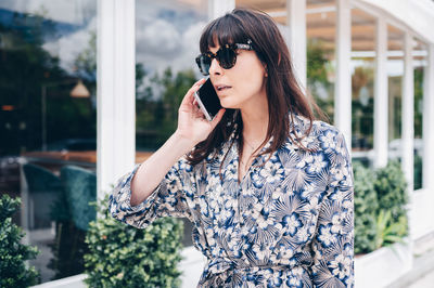 Young woman using mobile phone outdoors