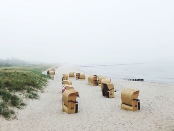 Hooded chairs on foggy beach