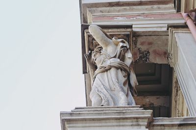 Low angle view of statue against building