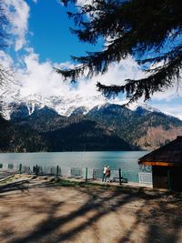 Scenic view of lake by mountains against sky