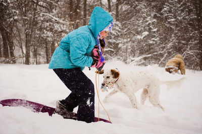 Dog playing with snow