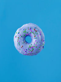 Directly above shot of donut against blue background
