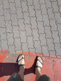 Low section of woman standing on tiled floor