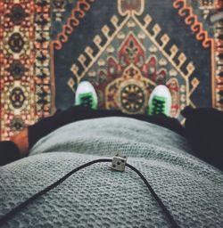 Low section of man standing on carpet