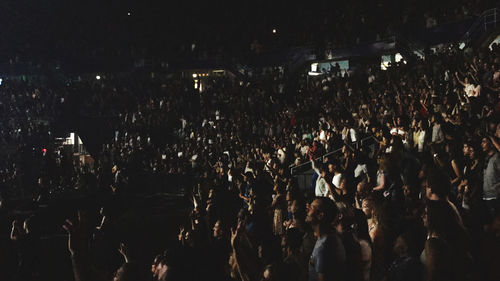 Crowd at music concert in city at night