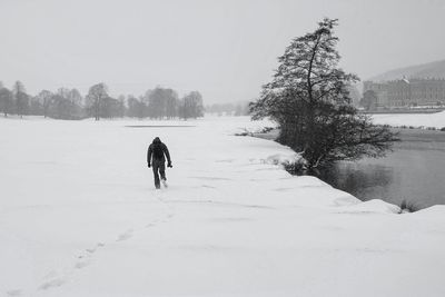 People walking on snow covered landscape