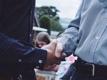 Midsection of man shaking hands