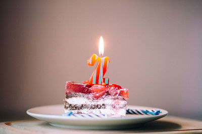 Close-up of burning candles on birthday cake