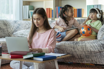 Two women sitting on a book