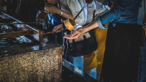 Midsection of woman holding ladle