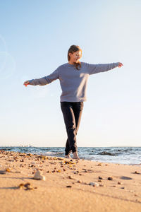Health and wellness. young woman in sport clothes enjoying sunrise walking at the beach
