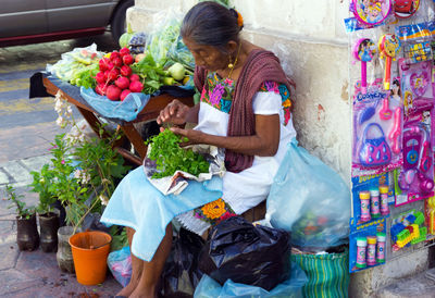 Woman holding multi colored umbrellas at market