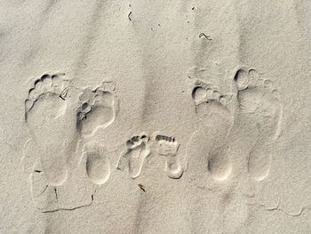 Close-up of footprints on sand at beach