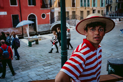 Portrait of man standing on street in city