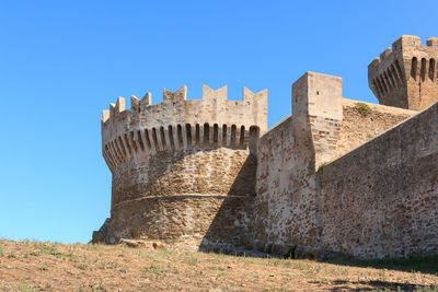 Low angle view of fort against blue sky