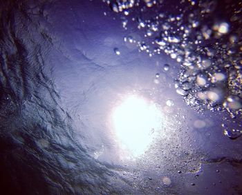 Close-up of illuminated water against sky