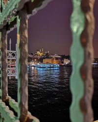 Illuminated buildings in city at waterfront