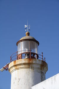 Low angle view of lighthouse against clear blue sky