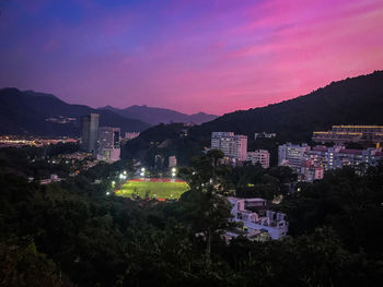 High angle view of illuminated buildings against sky at night