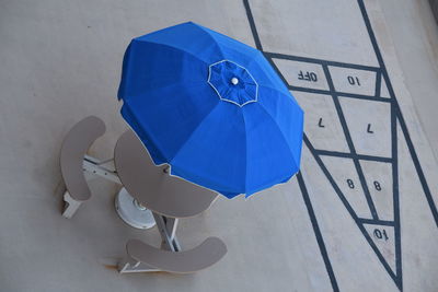 High angle view of blue umbrella on table