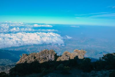 Scenic view of mountains against blue sky