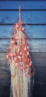 Close-up of rope tied on wooden wall