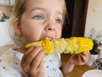 Close-up of woman holding corn