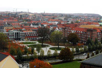 High angle view of houses in town against clear sky