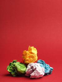 Close-up of multi colored roses against red background