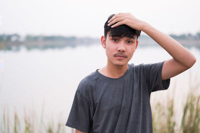 Portrait of teenage boy with head in hand