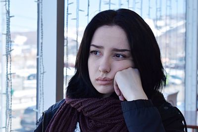 Woman against window