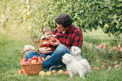 Full length of father and daughter in basket