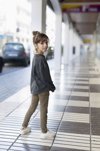 Portrait of girl standing in corridor