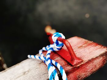 Close-up of rope tied on wood