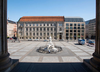 Statue in city against clear sky