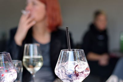 Midsection of people holding drink in restaurant