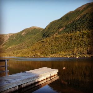 Scenic view of lake and mountains against clear sky