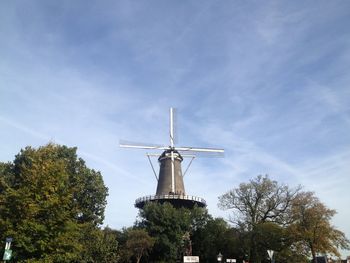 Low angle view of windmill against sky