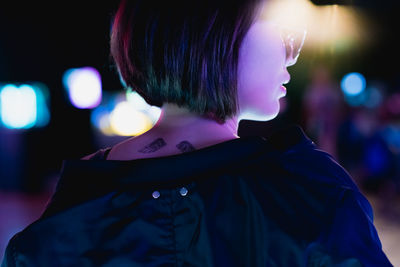 Close-up portrait of woman looking at night