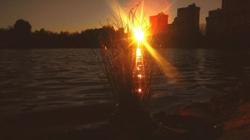 Sun shining over sea during sunset