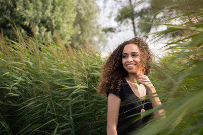 Portrait of smiling teenage girl with curly hair