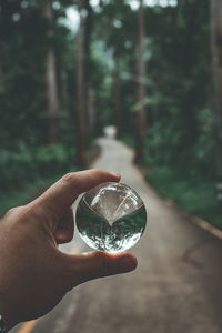 Close-up of hand holding glass against blurred background
