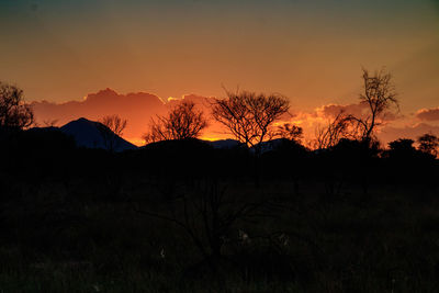 Scenic view of silhouette mountains against sky at sunset
