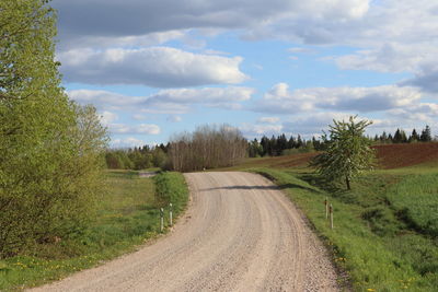 Road amidst trees against sky