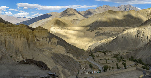 Scenic view of mountain range against cloudy sky