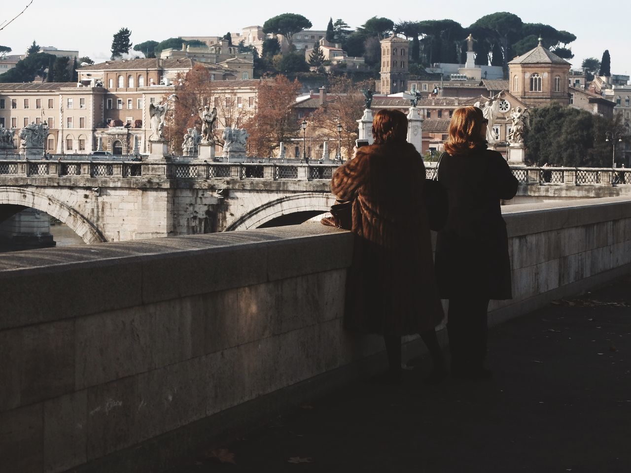 architecture, built structure, building exterior, men, rear view, city, lifestyles, full length, person, walking, leisure activity, city life, standing, railing, bridge - man made structure, casual clothing, connection