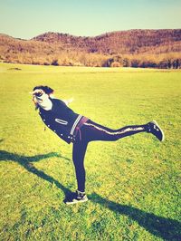 Full length of girl standing on grassy field